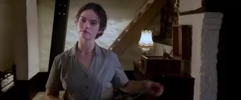 Lily James strips and bends over a table