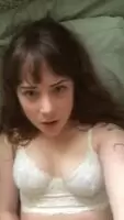 Adorable blue eyed brunette masturbates while looking into camera