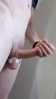 Rubbing my smooth, circumcised cock hard with my balls weighted down
