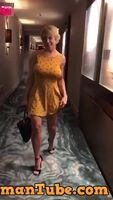 Busty blonde removes dress in hotel hallway