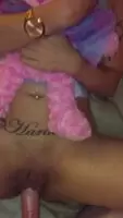 Holding her pink teddy while her daddy makes her feel good